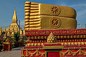 Vientiane, Laos - Pha That Luang, large gilded reclining Buddha within the temple area. 
